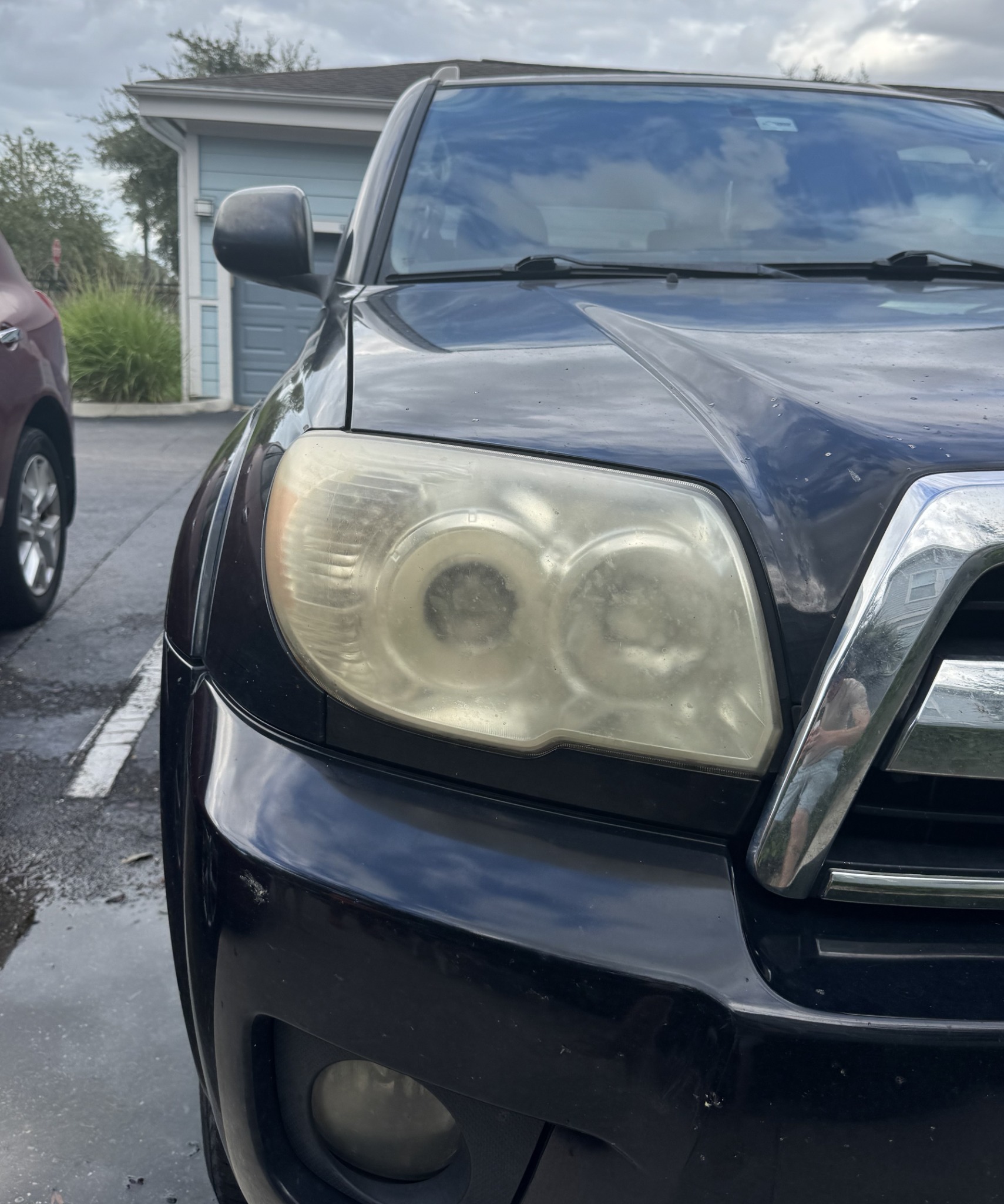 Black vehicle headlight before restoration